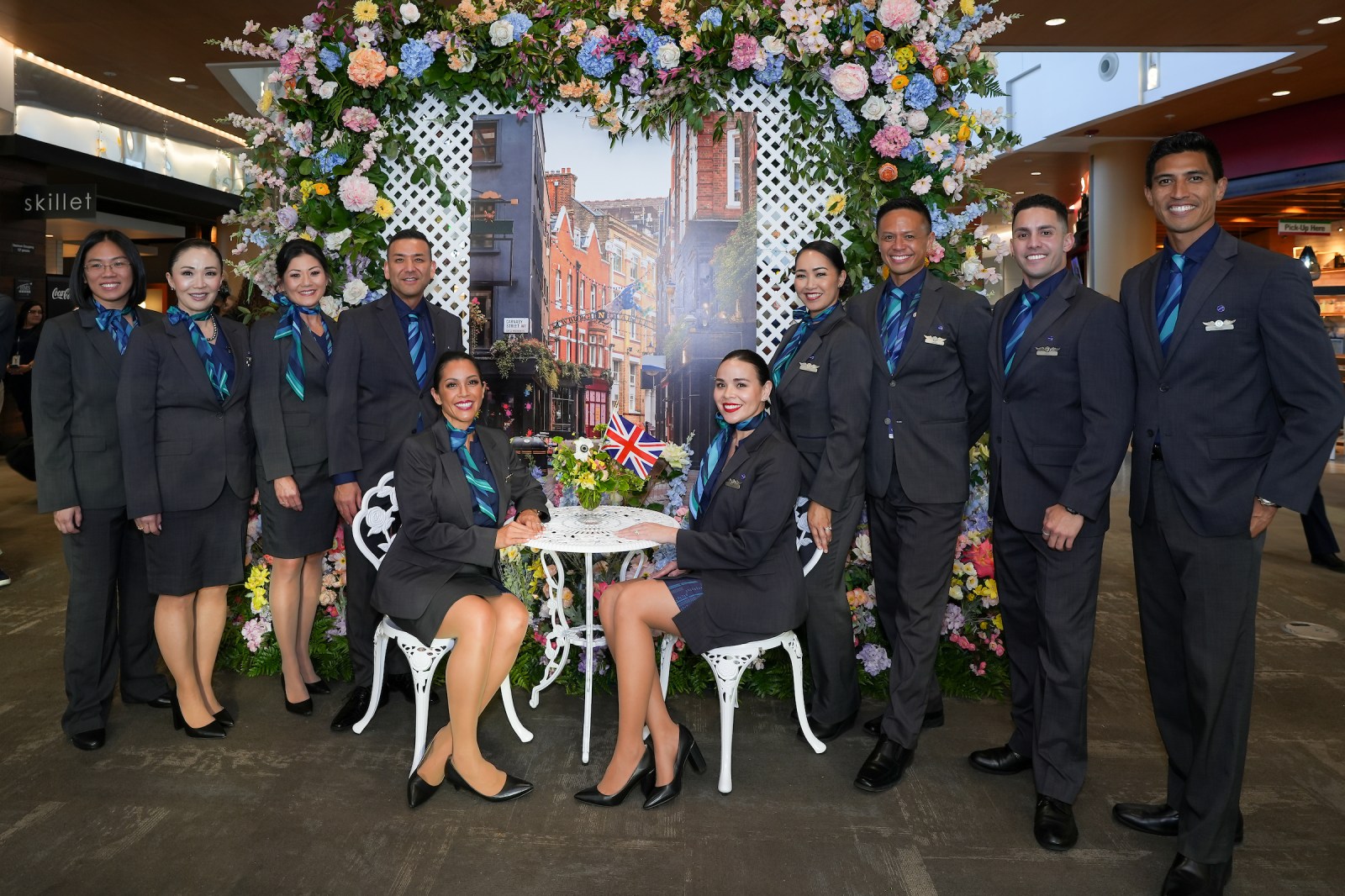 Alaska Airlines crew celebrating the Seattle to London inaugural flight